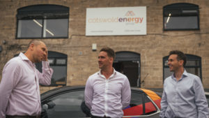 Cotswold Energy group founders, stood in front of business building. 