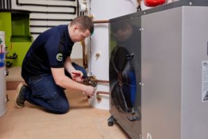 Contractor installing a heat pump