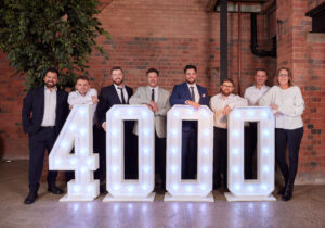 MCS contractors in front of LED 4000 sign, in celebration of reaching 4000 contractors.