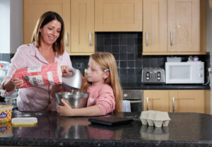 Mum and daughter baking in the kitchen.