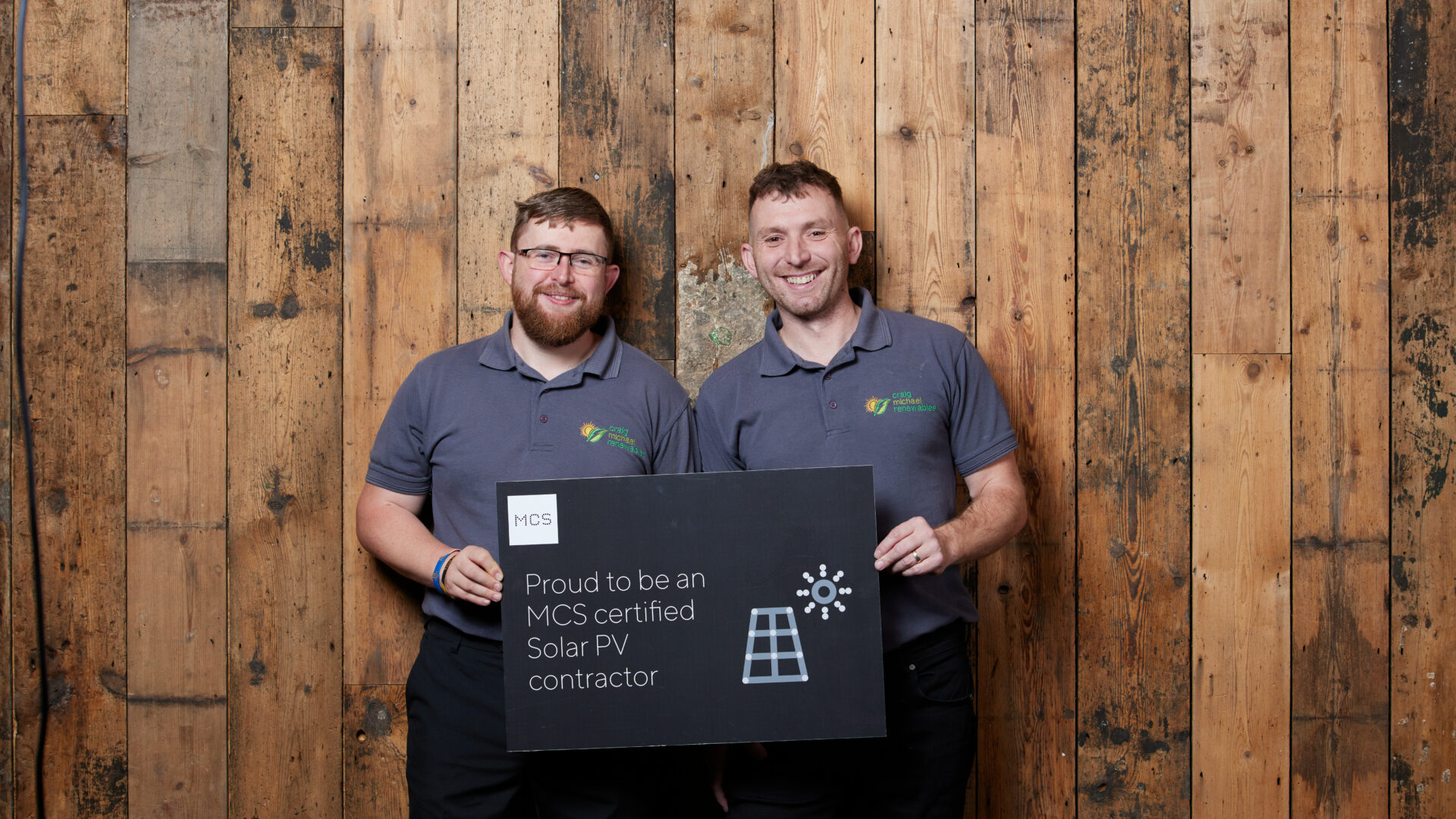 Craig Michael Renewables, Bernie & Craig, holding certified sign.