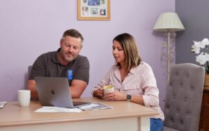 Sian and Chris looking at laptop.